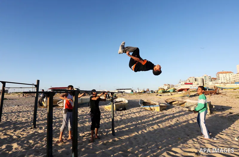 Palestinian youths show their parkour skills at the beach of Gaza city on March 04, 2016. Photo by Mohammed Asad