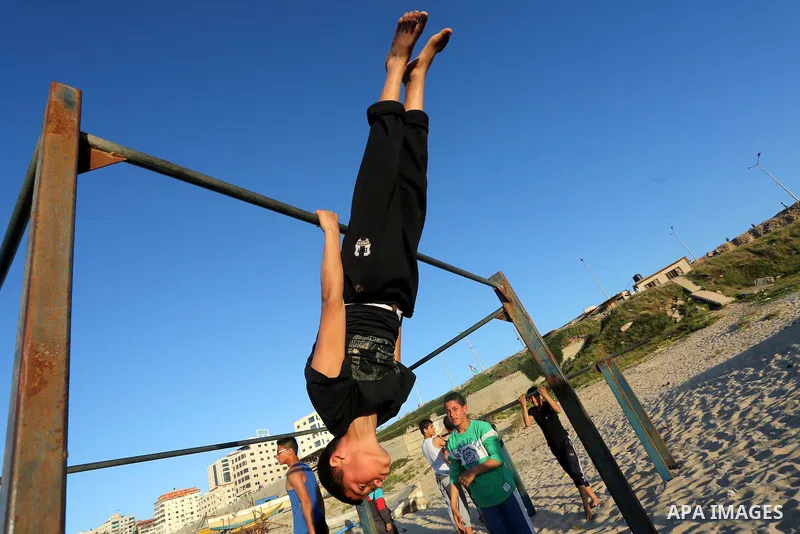 Palestinian youths show their parkour skills at the beach of Gaza city on March 04, 2016. Photo by Mohammed Asad