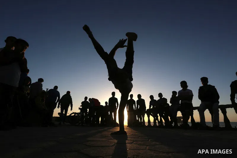 Palestinian youths show their parkour skills at the beach of Gaza city on March 04, 2016. Photo by Mohammed Asad