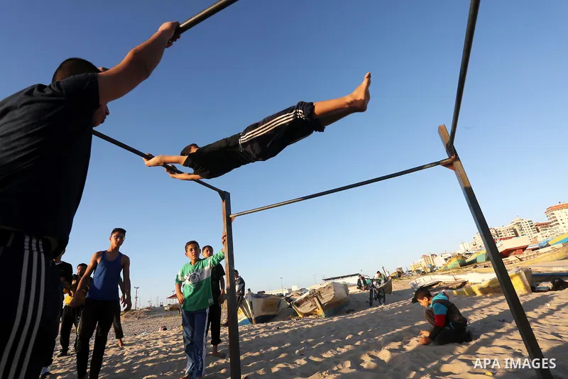 Palestinian youths show their parkour skills at the beach of Gaza city on March 04, 2016. Photo by Mohammed Asad