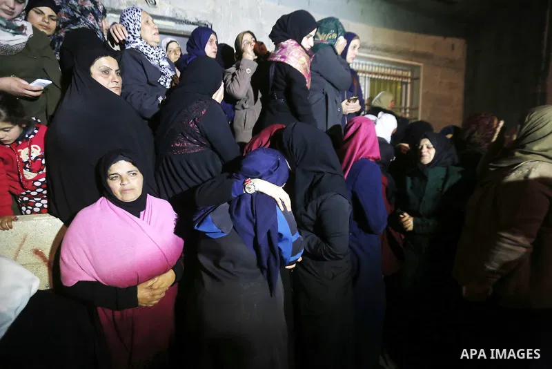 Relatives mourn during the funeral of Palestinian woman Amani Sbateen, who the Israeli military said was shot dead by Israeli troops after she rammed her car into an Israeli soldier on Friday, in the village of Hussan, s...