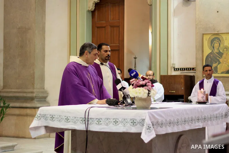 Clergymen pray before the altar in memory of Italian PhD student Guilio Regeni, who was tortured and killed in the capital in January, at Saint Joseph's Roman Catholic Church in Cairo, Egypt March 5, 2016. Photo by Amr S...
