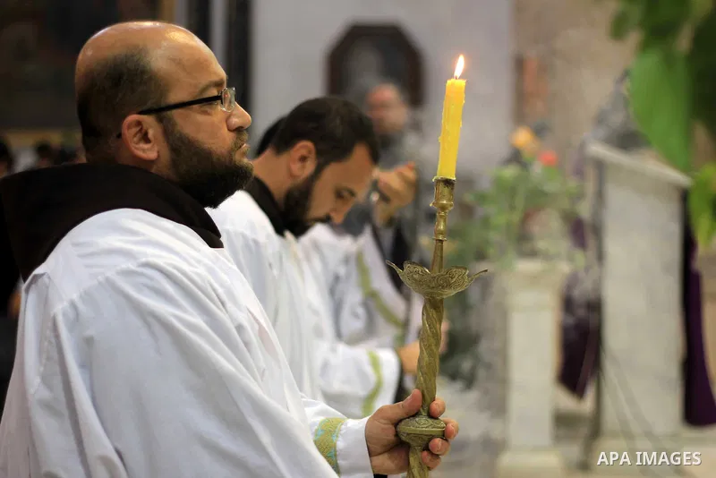 Clergymen pray before the altar in memory of Italian PhD student Guilio Regeni, who was tortured and killed in the capital in January, at Saint Joseph's Roman Catholic Church in Cairo, Egypt March 5, 2016. Photo by Amr S...
