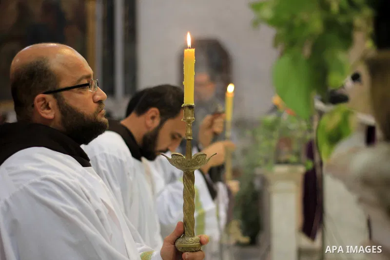 Clergymen pray before the altar in memory of Italian PhD student Guilio Regeni, who was tortured and killed in the capital in January, at Saint Joseph's Roman Catholic Church in Cairo, Egypt March 5, 2016. Photo by Amr S...