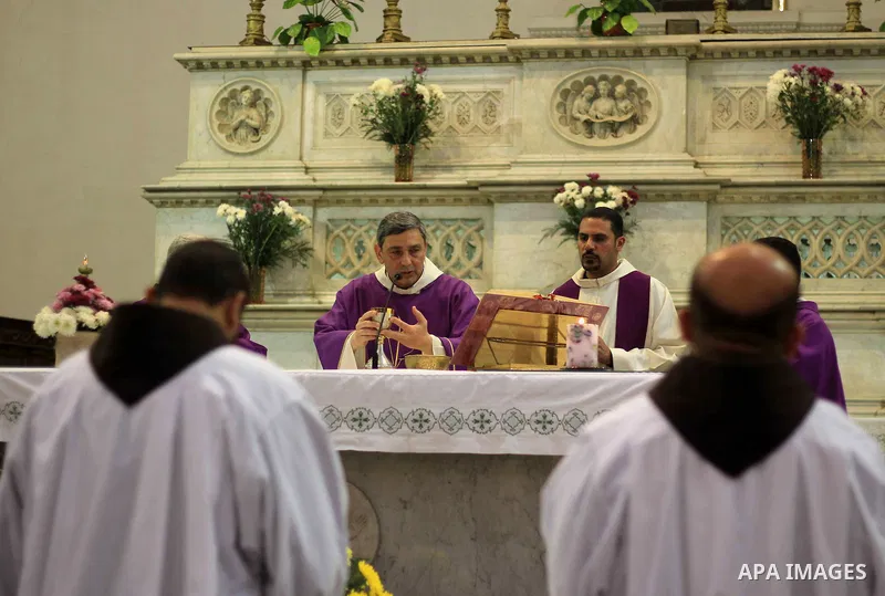 Clergymen kneel before the altar in memory of Italian PhD student Guilio Regeni, who was tortured and killed in the capital in January, at Saint Joseph's Roman Catholic Church in Cairo, Egypt March 5, 2016. Photo by Amr...