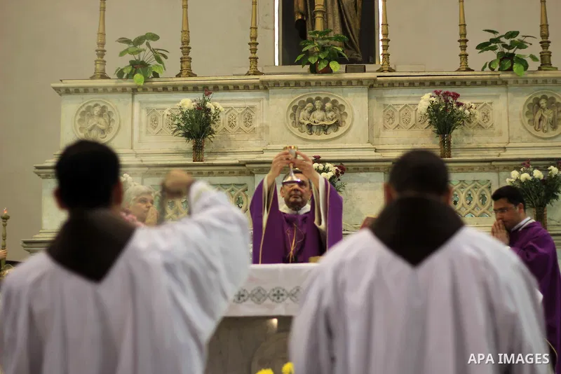 Clergymen kneel before the altar in memory of Italian PhD student Guilio Regeni, who was tortured and killed in the capital in January, at Saint Joseph's Roman Catholic Church in Cairo, Egypt March 5, 2016. Photo by Amr...
