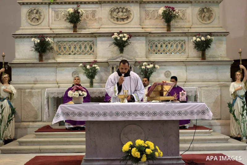 Clergymen pray before the altar in memory of Italian PhD student Guilio Regeni, who was tortured and killed in the capital in January, at Saint Joseph's Roman Catholic Church in Cairo, Egypt March 5, 2016. Photo by Amr S...