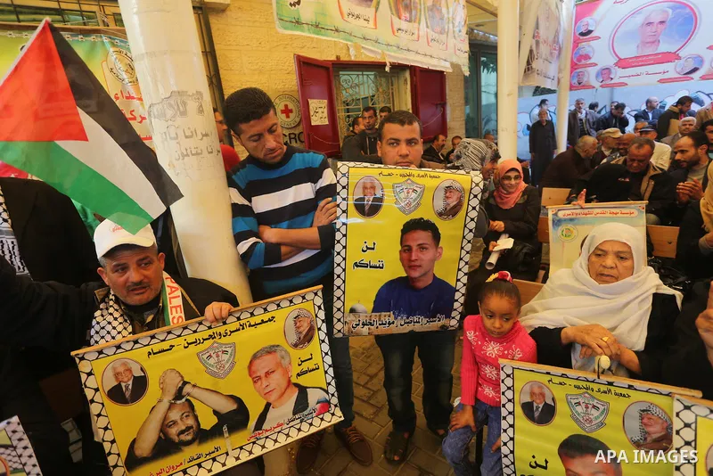 Palestinians take part in a protest demanding release the prisoners in Israeli jails, in front of Red cross office, in Gaza city, on March 7, 2016. Photo by Mohammed Asad