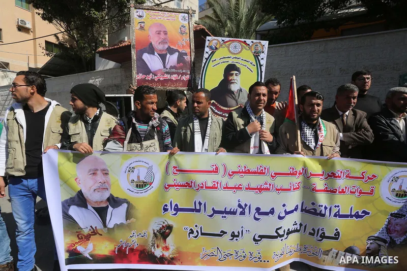 Palestinians take part in a protest demanding release the prisoners in Israeli jails, in front of Red cross office, in Gaza city, on March 7, 2016. Photo by Mohammed Asad