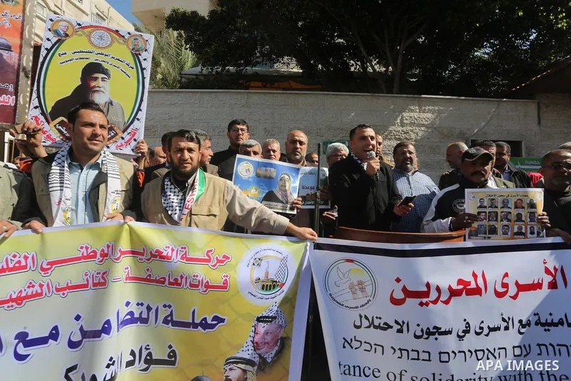 Palestinians take part in a protest demanding release the prisoners in Israeli jails, in front of Red cross office, in Gaza city, on March 7, 2016. Photo by Mohammed Asad