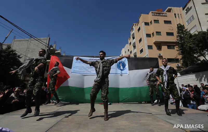 Palestinians take part in a march in front of the headquarters of the Red cross on the occasion of International Women's Day in Gaza City on March 7, 2016. Photo by Mohammed Asad