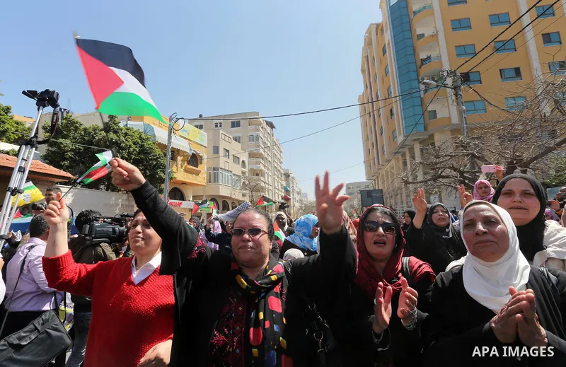 Palestinian women take part in a march in front of the headquarters of the Red cross on the occasion of International Women's Day in Gaza City on March 7, 2016. Photo by Mohammed Asad
