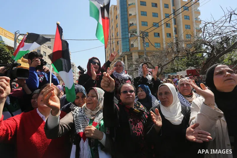 Palestinian women take part in a march in front of the headquarters of the Red cross on the occasion of International Women's Day in Gaza City on March 7, 2016. Photo by Mohammed Asad