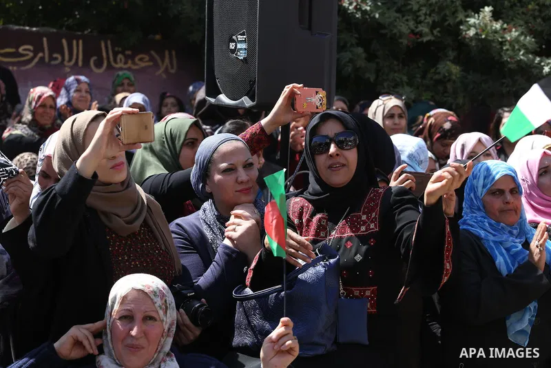 Palestinian women take part in a march in front of the headquarters of the Red cross on the occasion of International Women's Day in Gaza City on March 7, 2016. Photo by Mohammed Asad