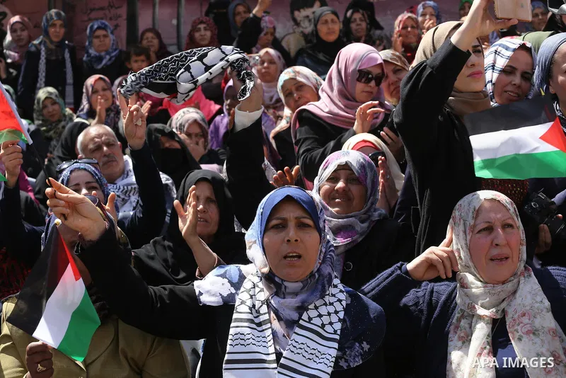 Palestinian women take part in a march in front of the headquarters of the Red cross on the occasion of International Women's Day in Gaza City on March 7, 2016. Photo by Mohammed Asad