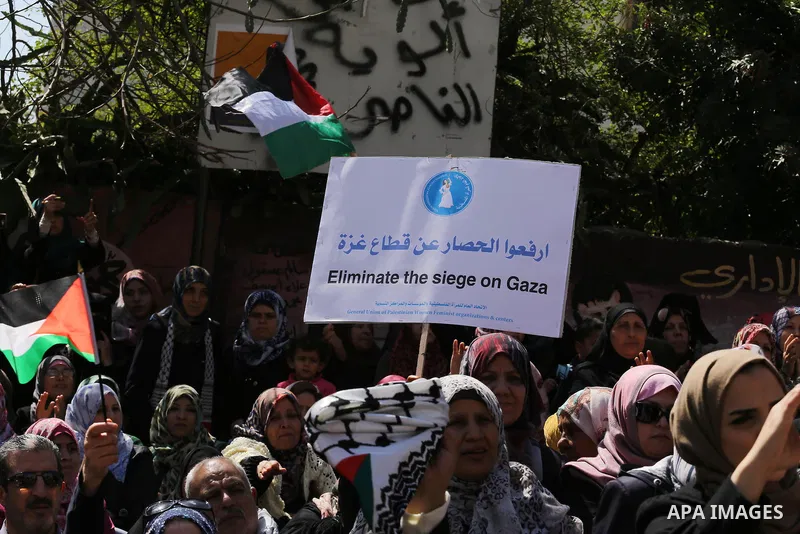 Palestinian women take part in a march in front of the headquarters of the Red cross on the occasion of International Women's Day in Gaza City on March 7, 2016. Photo by Mohammed Asad
