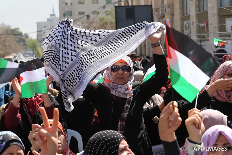 Palestinian women take part in a march in front of the headquarters of the Red cross on the occasion of International Women's Day in Gaza City on March 7, 2016. Photo by Mohammed Asad