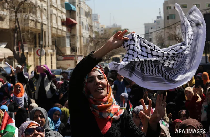 Palestinian women take part in a march in front of the headquarters of the Red cross on the occasion of International Women's Day in Gaza City on March 7, 2016. Photo by Mohammed Asad