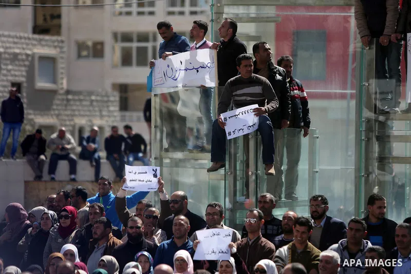 Palestinian teachers take part in a protest to demand their rights in front of the headquarters of the Council of Ministers, in the West bank city of Ramallah, March7, 2016. Photo by Shadi Hatem