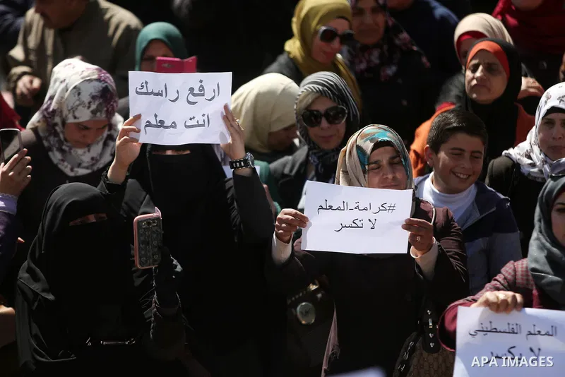 Palestinian teachers take part in a protest to demand their rights in front of the headquarters of the Council of Ministers, in the West bank city of Ramallah, March7, 2016. Photo by Shadi Hatem