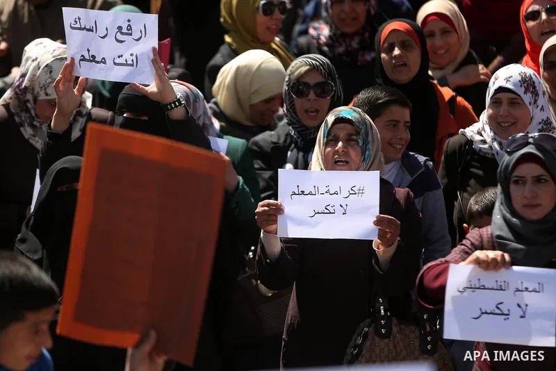 Palestinian teachers take part in a protest to demand their rights in front of the headquarters of the Council of Ministers, in the West bank city of Ramallah, March7, 2016. Photo by Shadi Hatem