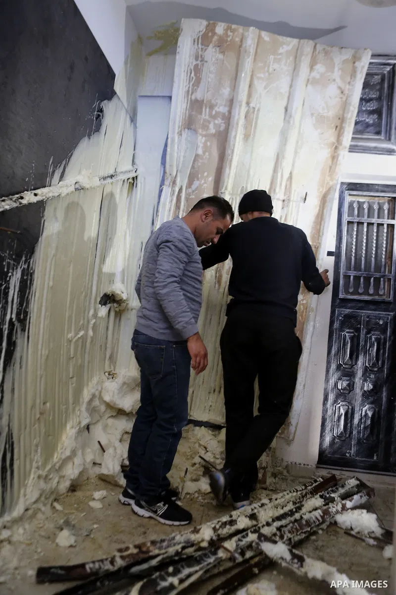 Palestinians check the damage house of Ibrahim Skafi that was demolished by the Israeli army in the West Bank city of Hebron March 8, 2016. Skafi was shot dead after he rammed an Israeli soldiers in Halhul north of Hebro...
