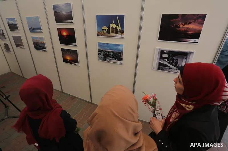 Palestinian women attend a photo gallery on the occasion of International Women's Day in Gaza City on March 8, 2016. People around the globe celebrate International Women's Day, which dates back to the beginning of the 2...