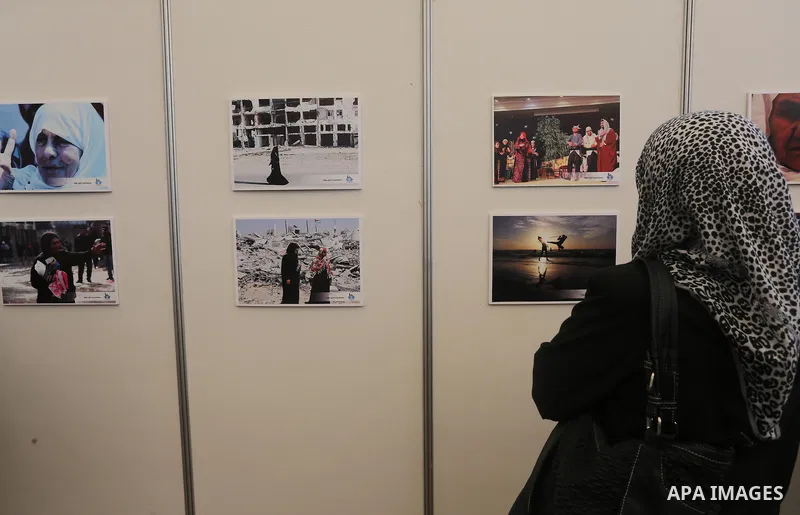 Palestinian women attend a photo gallery on the occasion of International Women's Day in Gaza City on March 8, 2016. People around the globe celebrate International Women's Day, which dates back to the beginning of the 2...