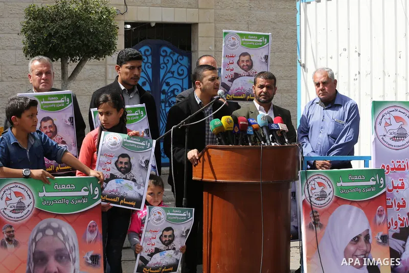 Palestinians hold placards during a protest in solidarity with Palestinian prisoners in Israeli jails, in front of high commissioner for human rights headquarters, in Gaza City on March 9, 2016. Photo by Mohammed Asad