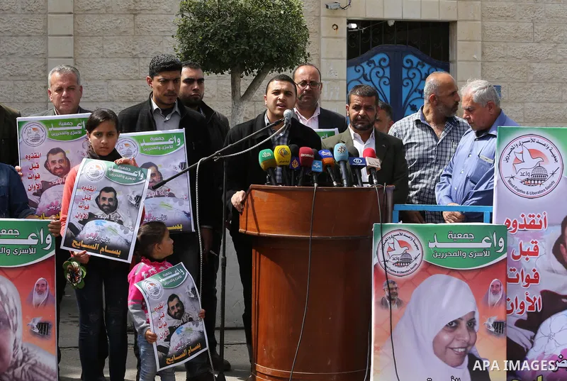 Palestinians hold placards during a protest in solidarity with Palestinian prisoners in Israeli jails, in front of high commissioner for human rights headquarters, in Gaza City on March 9, 2016. Photo by Mohammed Asad