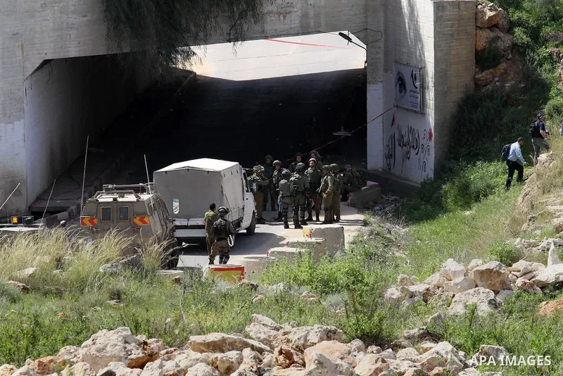Israeli police gather at the scene of a stabbing attack in the West Bank village of Salfit, 09 March 2016. Israeli forces shot dead a 16-year-old Palestinian boy after he attempted to carry out a stabbing attack at a mil...