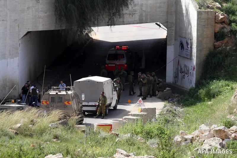 Israeli police gather at the scene of a stabbing attack in the West Bank village of Salfit, 09 March 2016. Israeli forces shot dead a 16-year-old Palestinian boy after he attempted to carry out a stabbing attack at a mil...