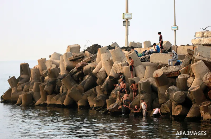 Palestininas dive into the Mediterranean Sea on the coast of Gaza City on March 09, 2016. Photo by Yasser Qudih