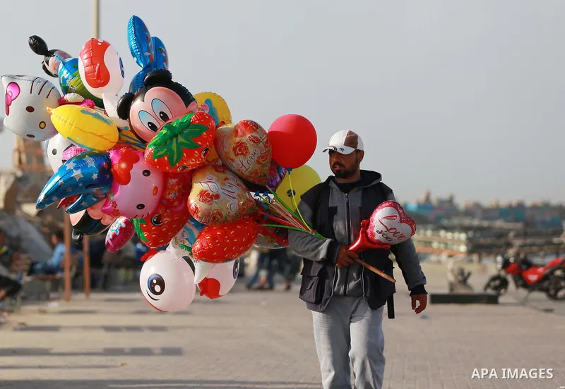 Palestinian man sells balloons at the beach of the Mediterranean sea on the coast of Gaza city, on March 09, 2016. Photo by Yasser Qudih