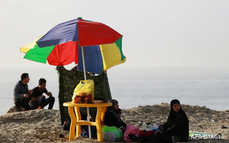 Palestinians enjoy a day at the beach of the Mediterranean sea on the coast of Gaza city, on March 09, 2016. Photo by Yasser Qudih