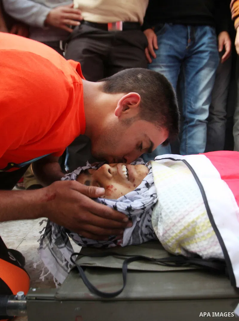 Relatives of Palestinian Ahmad Aamer, 16, who the Israeli military said was shot dead by Israeli soldiers after he tried to stab them mourn during his funeral in the West Bank village of Mas'ha near Salfit March 9, 2016....