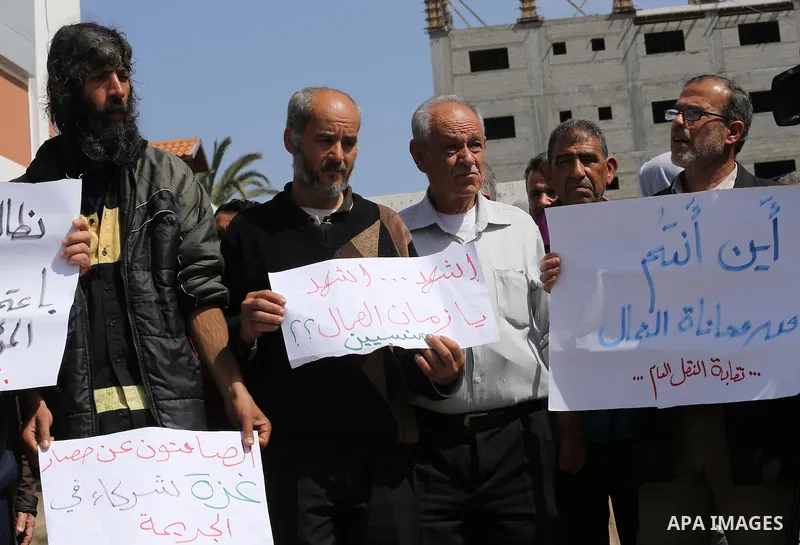 Palestinian laborers hold banners as they take part in a protest to demanding their rights, in front of the Legislative Council headquarters, in Gaza city, on March 10, 2016. Photo by Mohammed Asad