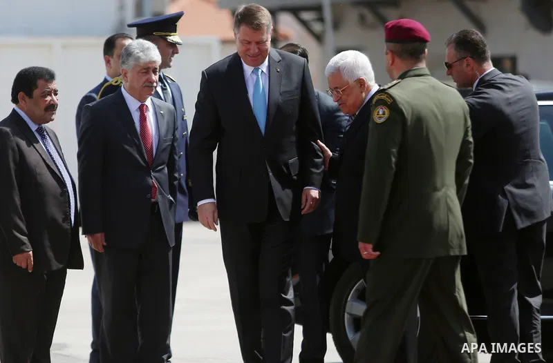 Romanian President Klaus Iohannis reviews honor guard with Palestinian president Mahmoud Abbas upon his arrival to the West Bank city of Ramallah on March 10, 2016. Photo by Shadi Hatem