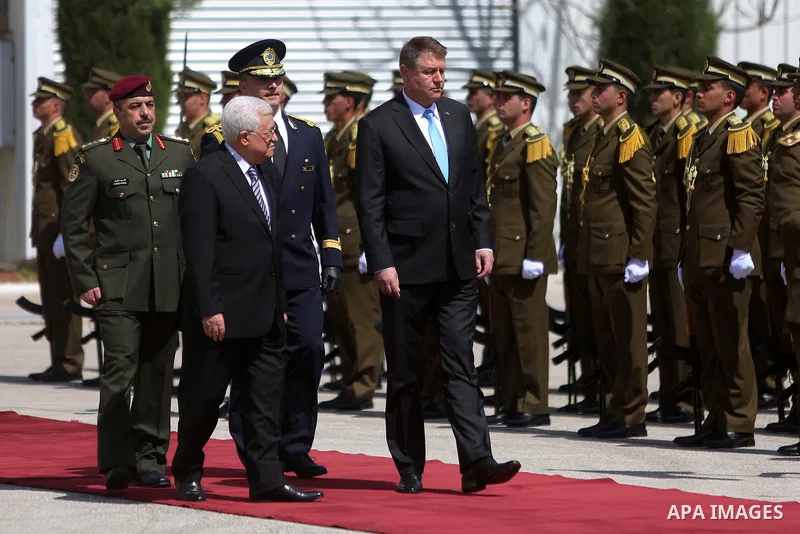 Romanian President Klaus Iohannis reviews honor guard with Palestinian president Mahmoud Abbas upon his arrival to the West Bank city of Ramallah on March 10, 2016. Photo by Shadi Hatem