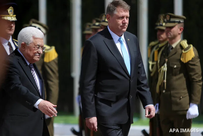 Romanian President Klaus Iohannis reviews honor guard with Palestinian president Mahmoud Abbas upon his arrival to the West Bank city of Ramallah on March 10, 2016. Photo by Shadi Hatem