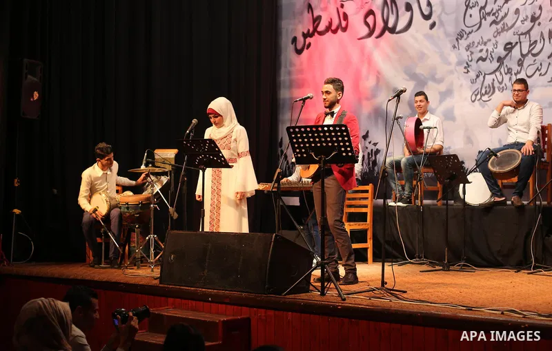 Members of Palestinian musical band perform during a singing ceremony in Gaza city on March 10, 2016. Photo by Mohammed Asad