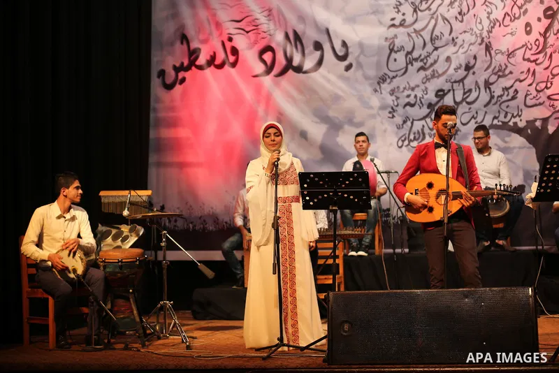 Members of Palestinian musical band perform during a singing ceremony in Gaza city on March 10, 2016. Photo by Mohammed Asad