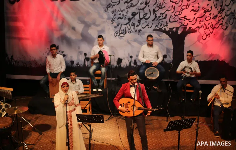 Members of Palestinian musical band perform during a singing ceremony in Gaza city on March 10, 2016. Photo by Mohammed Asad