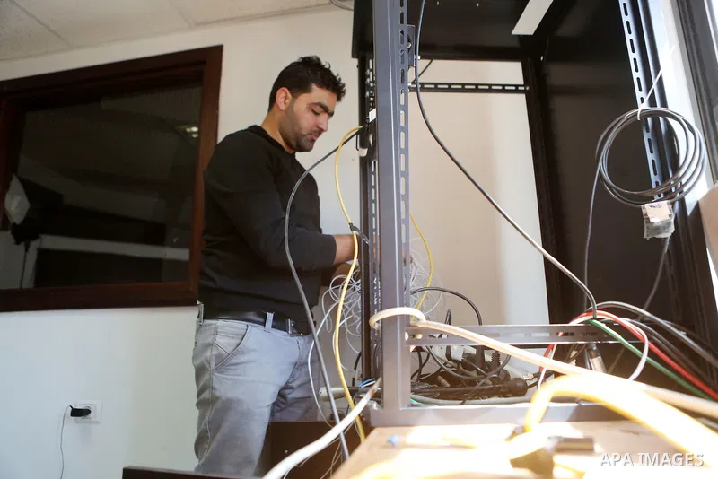 Palestinian employees of Palestine Today television inspect the damage at the station's offices after it had been raided by Israeli forces overnight on March 11, 2016, in the West Bank city of Ramallah. Israeli forces ra...