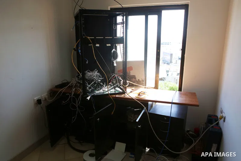Palestinian employees of Palestine Today television inspect the damage at the station's offices after it had been raided by Israeli forces overnight on March 11, 2016, in the West Bank city of Ramallah. Israeli forces ra...