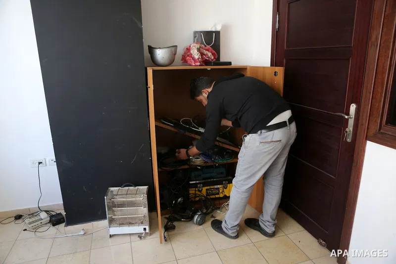 Palestinian employees of Palestine Today television inspect the damage at the station's offices after it had been raided by Israeli forces overnight on March 11, 2016, in the West Bank city of Ramallah. Israeli forces ra...