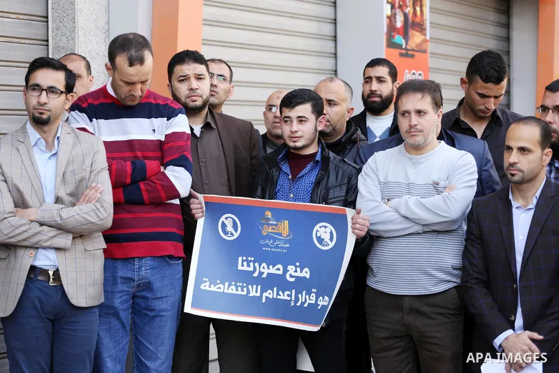 Palestinian Journalists take part during a protest to show solidarity with Palestine Today television after it had been raided by Israeli forces overnight on March 11, 2016 in Gaza city. Israeli forces raided the TV's of...