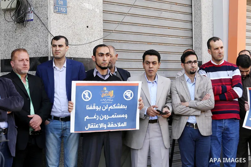 Palestinian Journalists take part during a protest to show solidarity with Palestine Today television after it had been raided by Israeli forces overnight on March 11, 2016 in Gaza city. Israeli forces raided the TV's of...