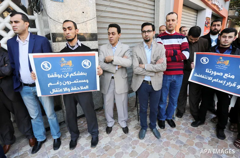 Palestinian Journalists take part during a protest to show solidarity with Palestine Today television after it had been raided by Israeli forces overnight on March 11, 2016 in Gaza city. Israeli forces raided the TV's of...