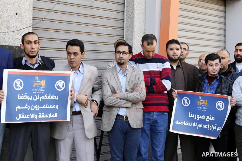 Palestinian Journalists take part during a protest to show solidarity with Palestine Today television after it had been raided by Israeli forces overnight on March 11, 2016 in Gaza city. Israeli forces raided the TV's of...